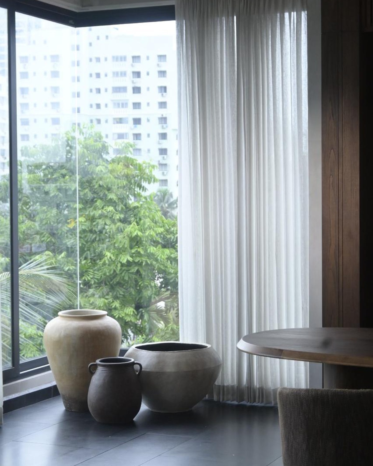 Terracotta vessels placed in an interior setting